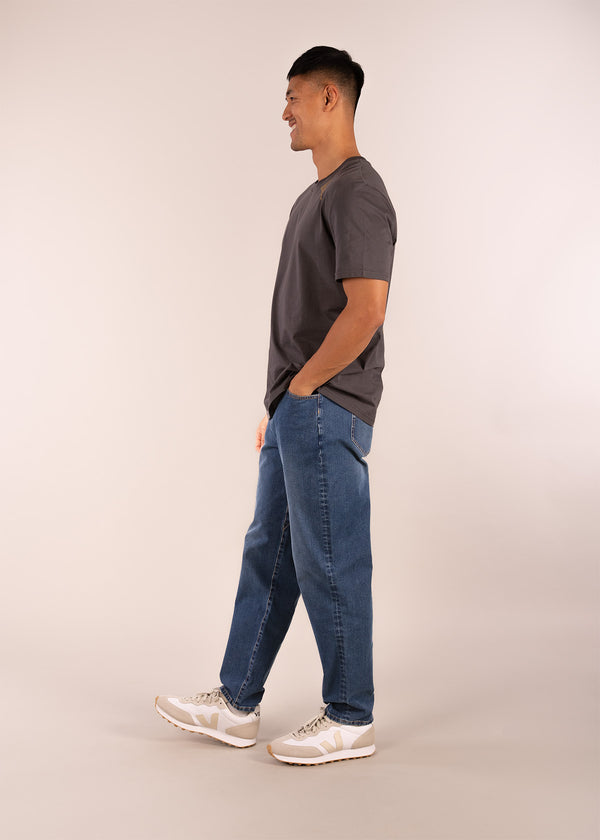 3rd rock sustainable movement denim jeans with a relaxed fit - Donald is 6ft 1″  with a 30" waist, 36" hips & a 33" inseam and is wearing a size 30LL. M